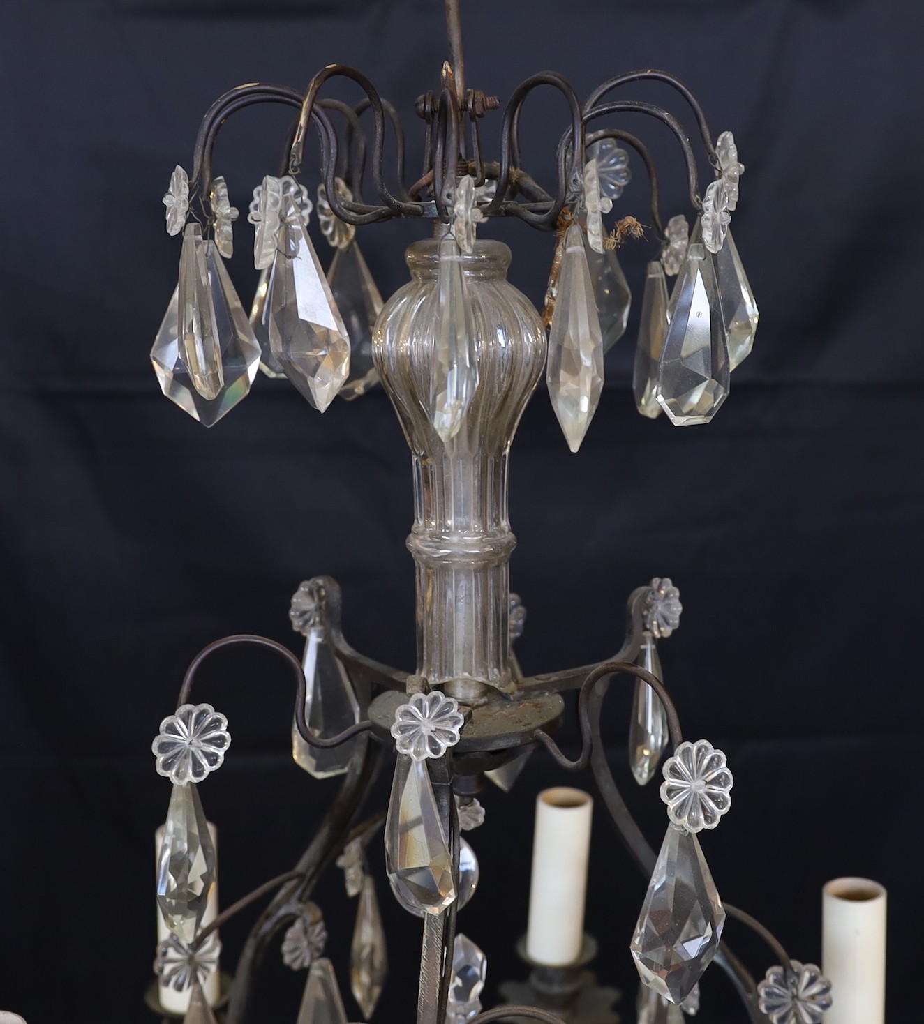 An early 20th century French bronze and cut glass six light chandelier hung with tear shaped and faceted drops, height 63cm. width 42cm